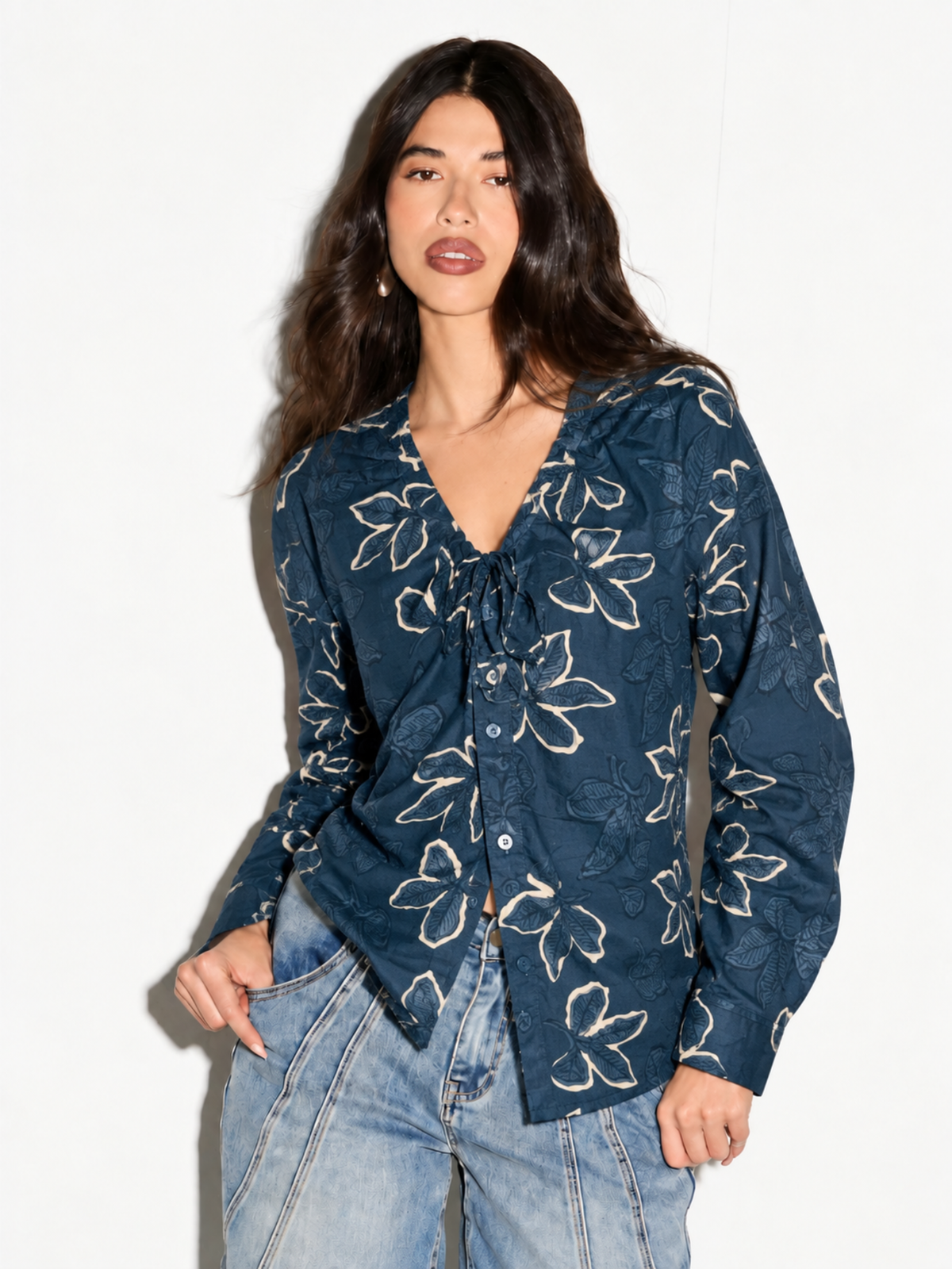 Model wearing Leher blue floral corset back shirt for women, front view with tie-neck V and jeans