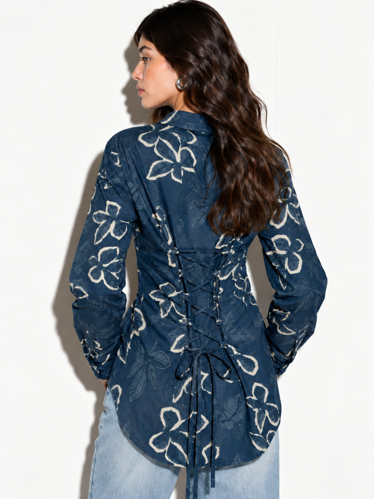 Back view of Leher blue floral corset back shirt with lace-up panel and tie ends