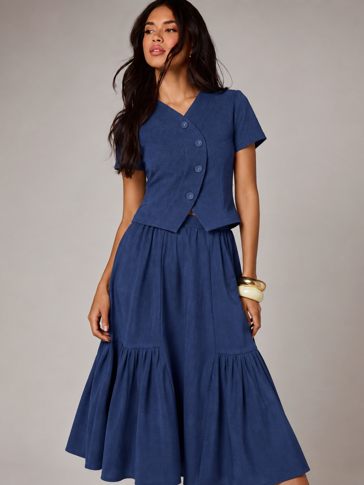 Woman in CHLOE blue linen top and tiered midi skirt co-ord set, front view