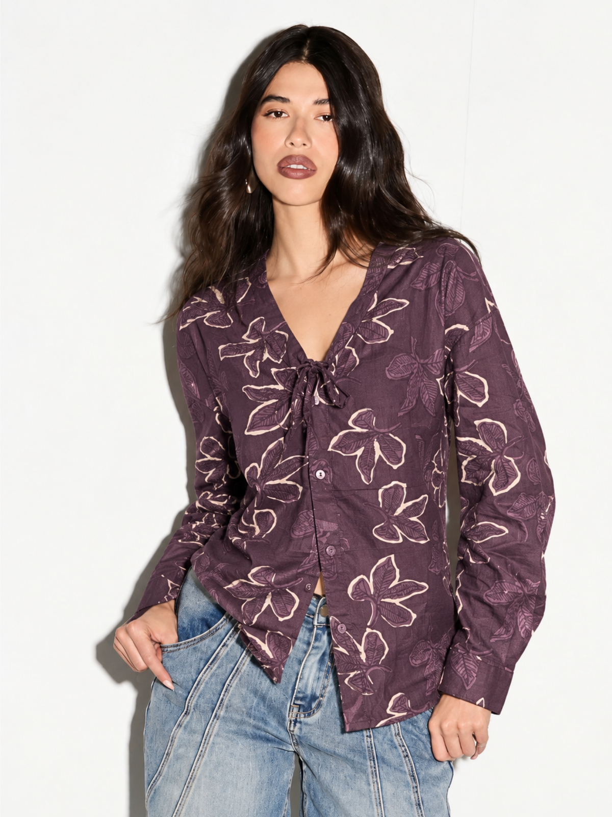 Model wearing Leher mauve floral corset back shirt for women, front view with tie-neck V and jeans